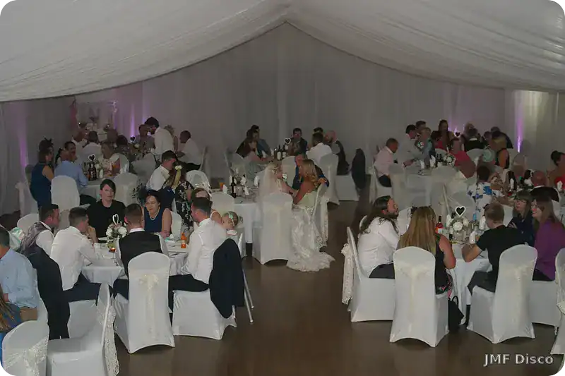 Small wedding reception with guests dining together at a venue in Kent